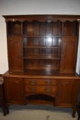 An Arts and Crafts oak dresser, having brass and copper details, width approx 153cm