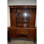 An Arts and Crafts oak dresser, having brass and copper details, width approx 153cm