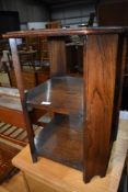 An early to mid 20th Century oak occasional table/bookshelf