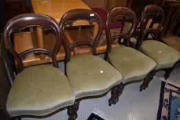 A set of four Victorian mahogany balloon back chairs having turned legs and later green dralon