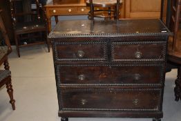 An early 20th century dark stained chest of 2 short and 2 long drawers on turned feet