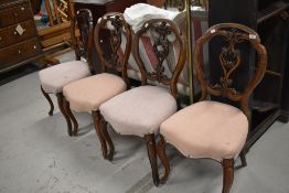A set of 4 Victorian mahogany ding salon chairs having foliate carved oval backs, with later