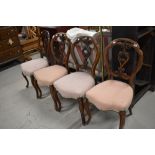 A set of 4 Victorian mahogany ding salon chairs having foliate carved oval backs, with later