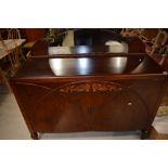 An early 20th Century oak sideboard having low mirror ledge back, width approx. 135cm