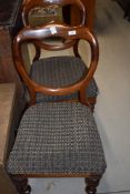 A pair of Victorian mahogany shaped ballooon back dining chairs on turned legs