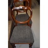 A pair of Victorian mahogany shaped ballooon back dining chairs on turned legs