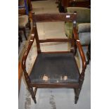 An early 19th century Regency design dining armchair having slat back and turned legs