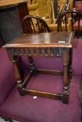 A late 20th century Jacobean style coffin stool on baluster legs