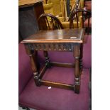 A late 20th century Jacobean style coffin stool on baluster legs