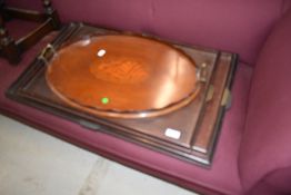 An Edwardian mahogany oval tray having shell inlay decoration and a trio set of graduated trays