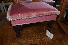 A reproduction footstool