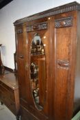 A 1920's 3 piece oak bedroom suite, comp, mirror door and drawer wardrobe, w 110cm, a chest of