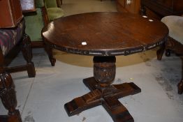 A late 20th century oak circular top pedestal coffee table