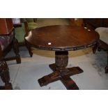 A late 20th century oak circular top pedestal coffee table