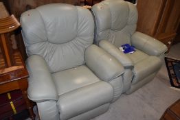 A pair of La-Z-Boy light green leather recliners, some wear to one more than the other