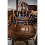 A dark stained Ercol drop leaf table and three (two plus one) dining chairs