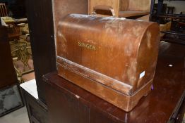 A vintage Singer sewing machine in dome carry case