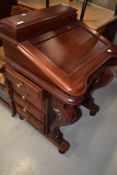 A reproduction mahogany Davenport of traditional design having scroll front supports