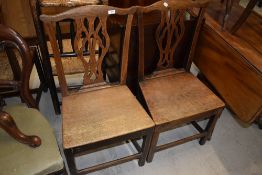 A pair of period oak solid seat dining chairs