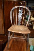 A traditional oak kitchen chair having slat back and turned frame