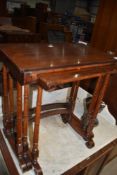 A rosewood nest of three table having fine turned legs