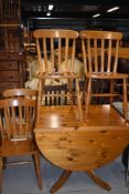 A set of 4 modern rubber wood slat back kitchen chairs and a modern pine drop leaf kitchen table