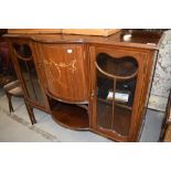 An Edwardian mahogany display cabinet base,having central bow and recess with sway inlay decoration,