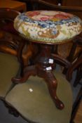 A Victorian mahogany piano stool having woolwork top