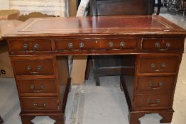 A late 20th century mahogany effect desk, having inset top and drawer pedestals, w 123cm