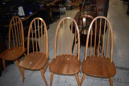 A set of four beech hoop and stick back kitchen chairs, labelled Ercol, mid to light colour