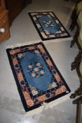 A pair of Chinese style small rugs