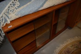 A vintage teak or sapele glazed double bookcase