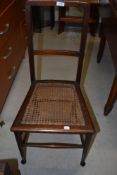 A pair of Edwardian cane seated bedroom chairs