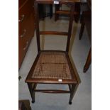 A pair of Edwardian cane seated bedroom chairs