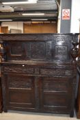 An 18th century and later oak court cupboard, having carved foliate decoration of traditional