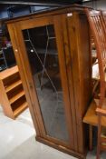 An early 20th Century golden oak tall display cabinet