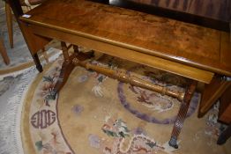 A reproduction Regency style coffee table having drop ends