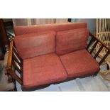 A vintage stained frame drop end settee, on shepherds castors