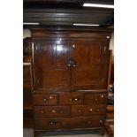 A period oak linen press having cupboard to top, and three over two over one drawer base, with