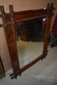 A Victorian Gothic style pitch pine wall mirror