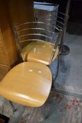 A pair of modern chrome and beech ply kitchen dining chairs