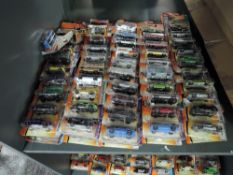 A shelf of modern Matcbox diecasts, all in blister packs, 100 in total