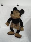 A 1930's Mickey Mouse straw filled soft toy having hand stitched nose and joints, original gloves