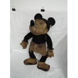 A 1930's Mickey Mouse straw filled soft toy having hand stitched nose and joints, original gloves