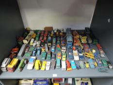A shelf of playworn diecasts including Matchbox Lesney, Corgi, Dinky etc