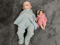 An early 20th century Armand Marseille bisque headed doll having sleep eyes, open mouth with two