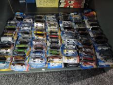 A shelf containing 140 Mattel Hot Wheels diecasts all in blister card packs including 2008 40 year