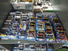 A shelf containing 140 Mattel Hot Wheels diecasts all in blister card packs including 2008 40 year