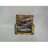 A Corgi diecast, James Bond Aston Martin with driver and two bandits, on inner card display stand