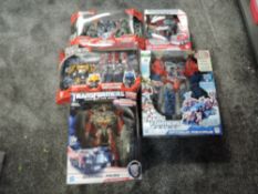 Five modern Hasbro Transformer Toys, Optimus Prime, Sentinel Prime, Optimus Maximus and two